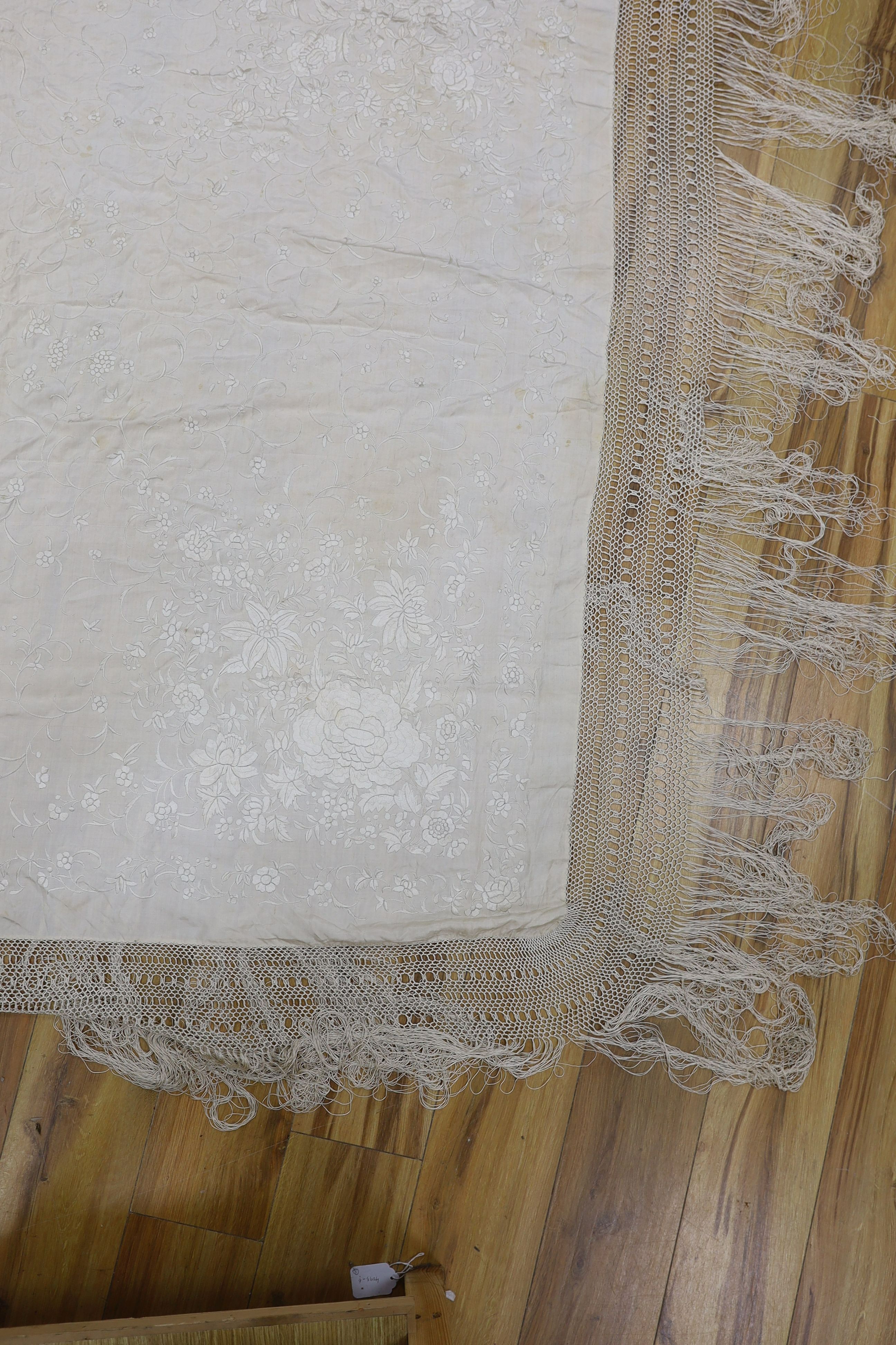 A 19th century cream embroidery on cream silk shawl together with a smaller later shawl